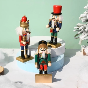 Three 15cm wooden nutcracker soldiers with colorful uniforms on a festive snowy stage