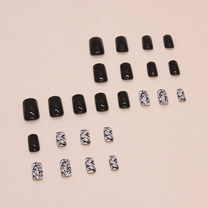 Short square press-on nails in glossy black and white geometric cracked pattern