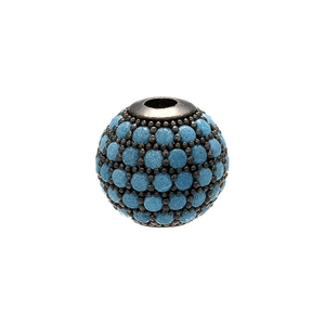 Macro close-up of a black metal bead micro-paved with turquoise stones for DIY jewelry