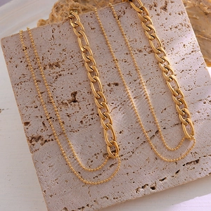 Minimalist double-layer gold beaded and Cuban chain necklace set on natural stone base
