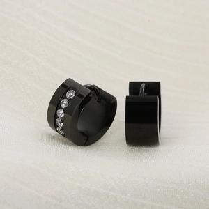 Macro shot of black stainless steel hinged hoop earrings with vertical zircon inlay