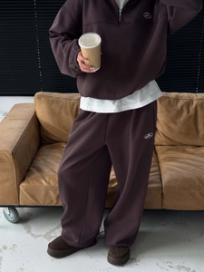 Detail of dark brown half-zip fleece tracksuit featuring high-quality knit cotton fabric
