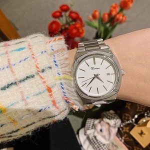 Close-up of silver steel band watch with white square dial and calendar function