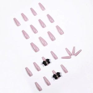 Glossy long coffin press-on nails in dusty pink with 3D black bows and gold accents