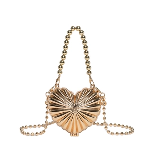 Golden heart-shaped metal handbag with shell texture and beaded top handle for women