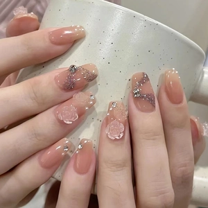 Pink gradient press-on nails with 3D white camellia flowers, pearls and glitter accents
