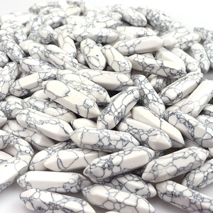 Close-up of bulk natural white turquoise double-pointed hexagonal crystal columns