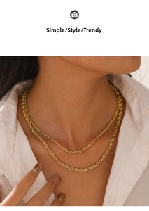 Detail shot of a layered 3mm and 4mm gold rope chain necklace on a model's neck