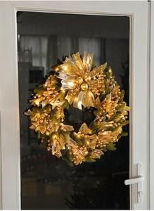 Detail of 50cm Christmas wreath with warm LED lights and golden berries on door