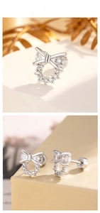 Macro view of silver bow-shaped stud earrings featuring clear cubic zirconia and flat screw backs