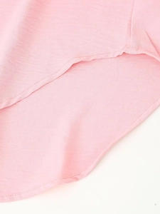 Detail of pink chiffon set showing the curved hem and lightweight textured woven fabric