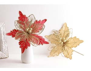 Detailed close-up of mesh Christmas flowers with gold glitter and berry stamens