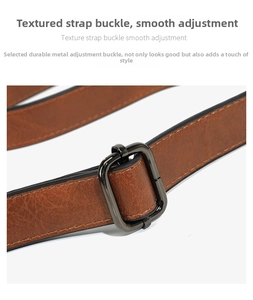 Detailed close-up of brown textured leather strap with adjustable gunmetal buckle