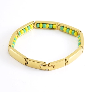 Detailed close-up of 18K gold stainless steel bracelet with green and yellow beads