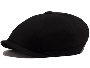 Detailed close-up of a classic black newsboy cap with cotton twill texture and metal button