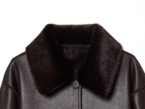 Close-up of deep brown faux leather jacket featuring a thick premium dark fur collar