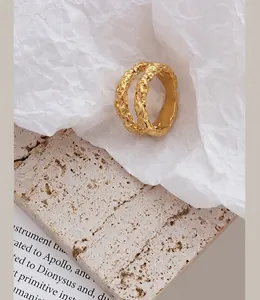Macro detail of gold-plated double-layer ring with unique hammered tin foil texture