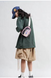 Pink candy-colored PVC crossbody bag shown on a model for transparency and size scale