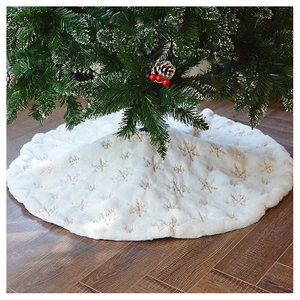 White faux fur Christmas tree skirt with golden sequin snowflake embroidery on floor