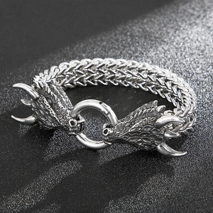 Macro shot of retro dragon head bracelet with detailed scales and woven texture