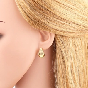 Elegant gold teardrop earrings with intricate textured detailing shown on a model