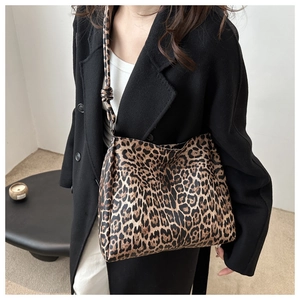 Close-up of leopard print tote bag texture and patterns on wide shoulder strap