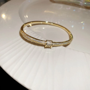 Close-up of 18k gold plated snake-style cuff bracelet with micro-paved zircons
