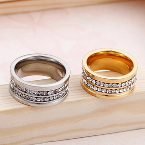 Polished titanium steel rings with double row rhinestones on rustic wood background