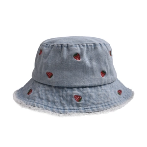 Detail of light blue denim bucket hat featuring red strawberry embroidery and frayed edges