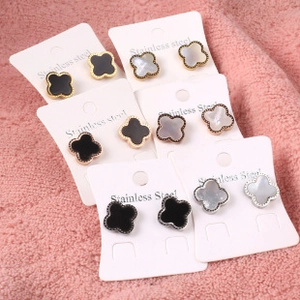 Detail of clover earring set in gold and silver stainless steel with black and white inlay