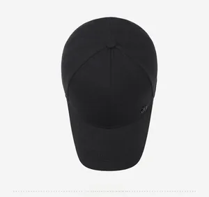 Top view of black cotton baseball cap showing 6-panel crown and metal logo detail