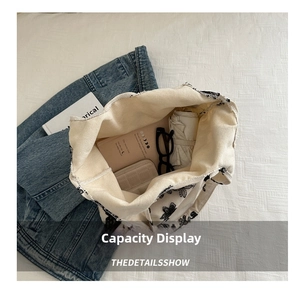 Top view of white canvas tote bag showing interior space with umbrella and accessories