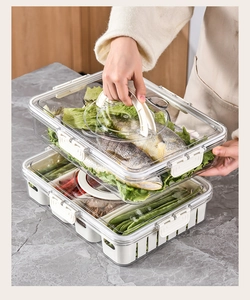 Close-up of clear PET food storage containers with dividers and easy-carry handles