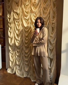 Detail of premium beige pleated knit texture on long sleeve polo top and wide leg pants