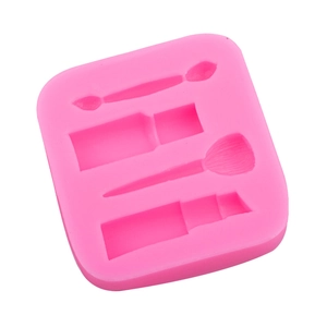 Pink silicone fondant mold featuring lipstick and makeup brush shapes for cake decorating