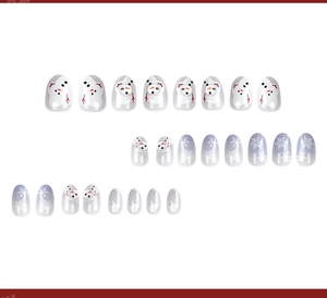 Detail of Christmas press-on nails with snowman art and purple snowflake gradients