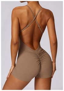 Close-up of the cross-back straps and ruched detailing on the brown sports bodysuit