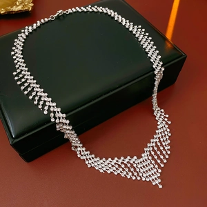 Macro shot of sparkling silver tassel necklace with rhinestones on a leather box