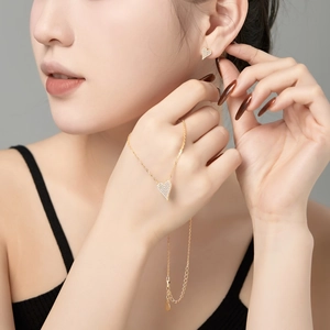 Elegant gold heart jewelry set including a necklace and earrings with pave zircon