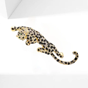 Sparkling leopard brooch in gold finish with black enamel spots and green crystal eyes