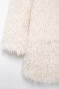 Close-up of white faux fur coat sleeve showing high-quality fluffy texture and glossy fibers