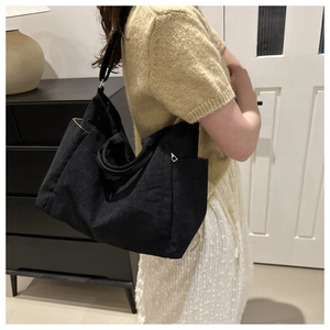 Detail of black corduroy tote bag showing spacious design and soft vintage texture