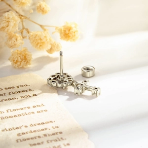 Silver heart cross cartilage stud earring with screw back on vintage background