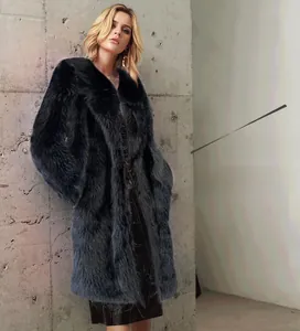 Detailed close-up of a long black faux fur coat with a large lapel collar and glossy finish