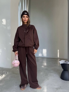 Detail of dark brown oversized tracksuit set with zipper jacket and wide-leg sweatpants