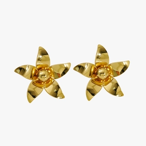 Macro shot of minimalist gold five-petal flower stud earrings with a polished metallic finish