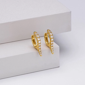 Detail of 925 sterling silver stamp on gold tapered earrings with clear gemstones