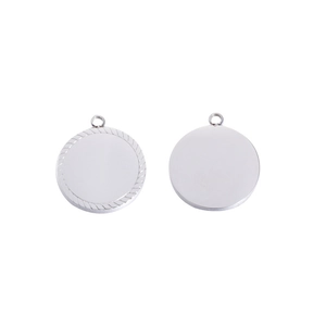 Close-up of silver mirror-polished stainless steel round pendants with scalloped edge detail