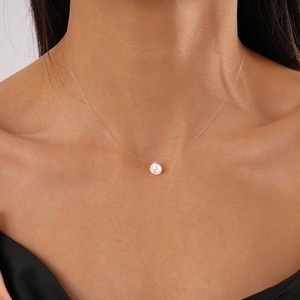 Elegant invisible fishing line necklace with a single round cubic zirconia pendant on neck