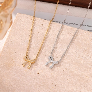 Elegant hollow bow pendant necklaces in gold and silver finish with sparkling zircons